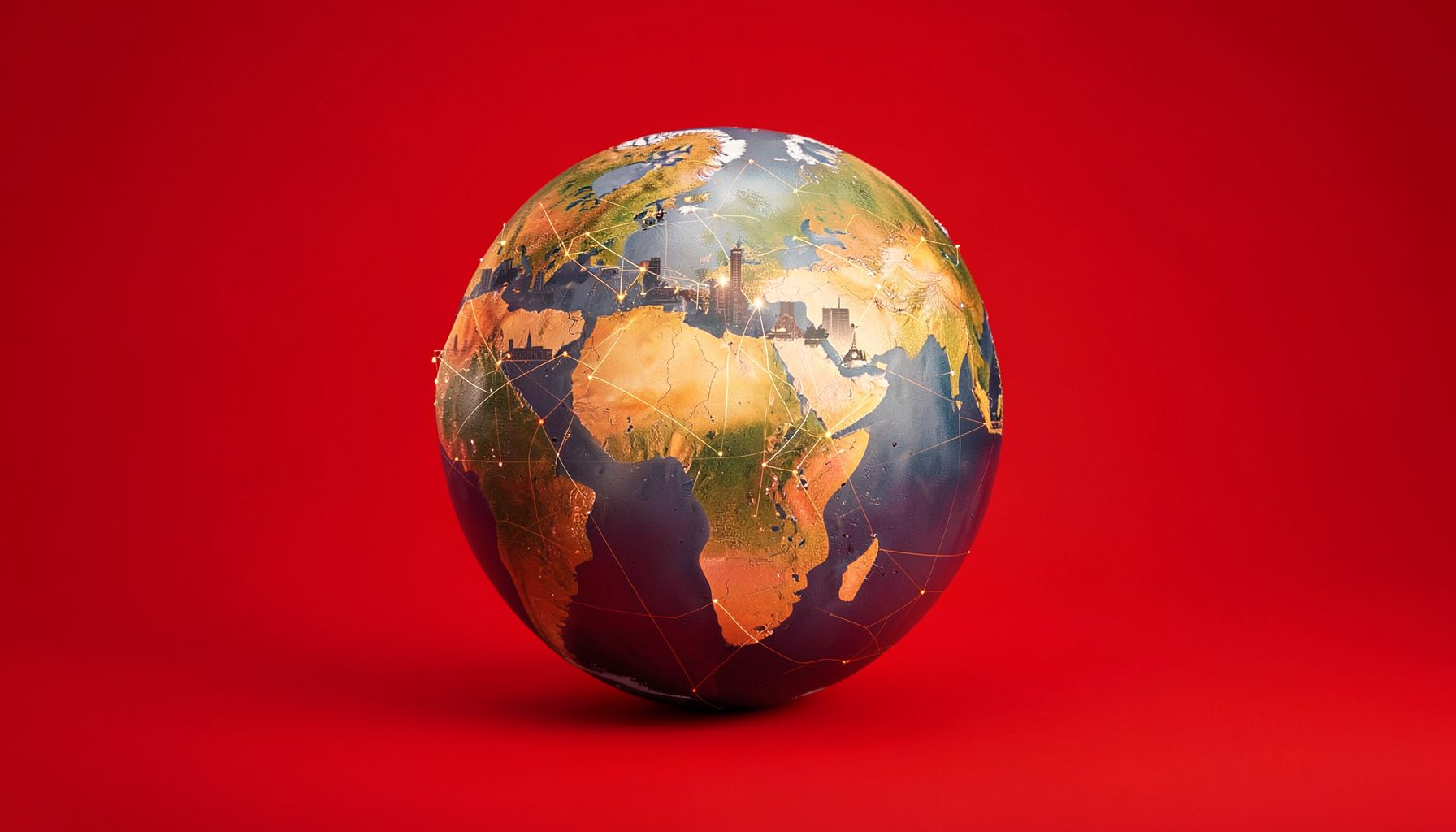 Globo terráqueo sobre un fondo cálido de tonos tierra y dorados, con siluetas de ciudades conectadas por líneas que simbolizan la red internacional de comercio justo